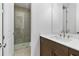 Bathroom features a modern vanity, white countertop, and tiled shower at 535 Pearl St, Cumming, GA 30040