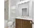 Well-lit bathroom with a white countertop and wood cabinets, plus a window for natural light at 535 Pearl St, Cumming, GA 30040