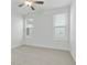 Neutral bedroom features a ceiling fan and two windows at 535 Pearl St, Cumming, GA 30040