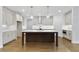 Bright kitchen with hardwood floors, stainless steel appliances, and a large center island at 535 Pearl St, Cumming, GA 30040