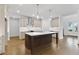 Spacious kitchen featuring hardwood floors, stainless appliances, a large island, and ample counter space at 535 Pearl St, Cumming, GA 30040