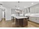 Elegant kitchen with hardwood floors, stainless steel appliances, island, and stylish pendant lighting at 535 Pearl St, Cumming, GA 30040