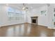 Light-filled living room featuring hardwood floors, a brick fireplace, and expansive windows at 535 Pearl St, Cumming, GA 30040