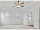 Spacious main bedroom with a ceiling fan and natural light at 535 Pearl St, Cumming, GA 30040