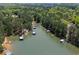 Aerial view showcasing waterfront properties, docks, and lush greenery, providing a serene lakeside living experience at 803 Willow Oak Dr, Woodstock, GA 30189