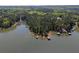 Aerial view showcasing waterfront properties, docks, and lush greenery, providing a serene lakeside living experience at 803 Willow Oak Dr, Woodstock, GA 30189