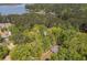 View of treed acreage with a glimpse of lake in the distance creates a private and serene property setting at 803 Willow Oak Dr, Woodstock, GA 30189