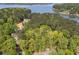 Aerial view of a home nestled within a lush forest, backing onto a lake, offers privacy and natural beauty at 803 Willow Oak Dr, Woodstock, GA 30189