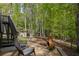 Backyard area with seating, a stone pathway, and surrounded by mature trees at 803 Willow Oak Dr, Woodstock, GA 30189