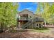 Beautiful home with a large deck, stairs leading to the yard, and an outdoor seating area, ideal for entertaining at 803 Willow Oak Dr, Woodstock, GA 30189