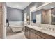 Bright bathroom featuring a soaking tub, double vanity, and tiled shower at 803 Willow Oak Dr, Woodstock, GA 30189