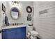 Stylishly decorated powder room with shiplap walls and blue vanity at 803 Willow Oak Dr, Woodstock, GA 30189