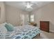 Bedroom displaying a bed with patterned bedding, a dresser, and a seating area by the window at 803 Willow Oak Dr, Woodstock, GA 30189