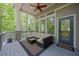 Inviting deck with cushioned seating, views of the surrounding trees, and direct access to the home's interior at 803 Willow Oak Dr, Woodstock, GA 30189