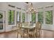 Dining room with chandelier, a large table, and large windows offering scenic views of the outdoors at 803 Willow Oak Dr, Woodstock, GA 30189