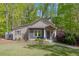 Inviting home exterior with charming landscaping, stone accents and a well-manicured lawn at 803 Willow Oak Dr, Woodstock, GA 30189