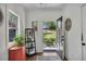 Bright foyer with hardwood floors, displaying an open door with a view of the landscaped yard at 803 Willow Oak Dr, Woodstock, GA 30189