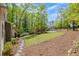 Well-manicured front yard with a walkway leading to the house, complemented by lush landscaping and trees at 803 Willow Oak Dr, Woodstock, GA 30189