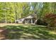 Charming home with a well-manicured lawn and mature trees, offering curb appeal and a sense of privacy at 803 Willow Oak Dr, Woodstock, GA 30189