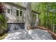 View of a home's garage with stone accents and lush greenery visible in the background at 803 Willow Oak Dr, Woodstock, GA 30189