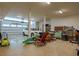 Spacious garage featuring a white car, storage shelves, and various outdoor equipment at 803 Willow Oak Dr, Woodstock, GA 30189