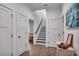 Hallway with hardwood floors, staircase, neutral paint, and decorative wall art at 803 Willow Oak Dr, Woodstock, GA 30189