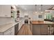 This kitchen offers stainless steel appliances, beautiful countertops, and a large island at 803 Willow Oak Dr, Woodstock, GA 30189