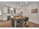 Bright kitchen features a large island, stainless steel appliances, and white cabinetry at 803 Willow Oak Dr, Woodstock, GA 30189