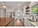 Bright kitchen featuring stainless steel appliances, a window, and open shelving at 803 Willow Oak Dr, Woodstock, GA 30189