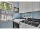 Cozy laundry room featuring natural light and washer and dryer units at 803 Willow Oak Dr, Woodstock, GA 30189