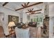 Spacious living room with exposed wood beams, a stone fireplace, and bright natural light at 803 Willow Oak Dr, Woodstock, GA 30189