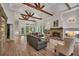 Spacious living room features a stone fireplace, wooden beams, and large windows with a view to the outside at 803 Willow Oak Dr, Woodstock, GA 30189