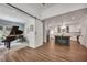 Open floor plan featuring a grand piano, sliding barn door, and kitchen island with barstools at 803 Willow Oak Dr, Woodstock, GA 30189