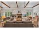 Bright living room featuring wood beams, a stone fireplace, and many windows for ample sunlight and views at 803 Willow Oak Dr, Woodstock, GA 30189