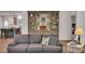 Living room view featuring a gray couch, hardwood floors, and a built-in bookshelf with decorative items at 803 Willow Oak Dr, Woodstock, GA 30189