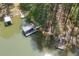 Aerial view of waterfront property with multiple docks and boat slips on a serene lake surrounded by mature trees at 803 Willow Oak Dr, Woodstock, GA 30189