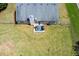 Aerial shot of the backyard with a patio set, manicured lawn, and fenced perimeter at 101 Javay Ct Ct, Villa Rica, GA 30180