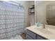 This bathroom features a decorative shower curtain, shelves and mirror at 101 Javay Ct Ct, Villa Rica, GA 30180