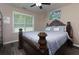 This bedroom features a ceiling fan, large window, and a decorative headboard to complete the space at 101 Javay Ct Ct, Villa Rica, GA 30180