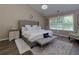 Bedroom featuring a cozy bed with a tufted headboard and natural lighting at 101 Javay Ct Ct, Villa Rica, GA 30180