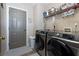 This laundry room includes modern appliances and overhead storage for optimal organization at 101 Javay Ct Ct, Villa Rica, GA 30180