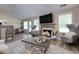 Bright living room with a fireplace, large windows, and elegant furniture at 101 Javay Ct Ct, Villa Rica, GA 30180