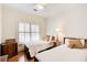 A cozy bedroom with two twin beds, wood floors, and a sunny window at 1015 Heatherbrooke Ln, Atlanta, GA 30324