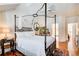 A main bedroom with a four poster bed with natural light and hardwood floors at 1015 Heatherbrooke Ln, Atlanta, GA 30324
