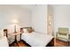 A bright bedroom with wood floors featuring twin beds and a sitting chair at 1015 Heatherbrooke Ln, Atlanta, GA 30324