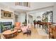 Spacious living room with fireplace, piano, and large windows, filled with natural light at 1015 Heatherbrooke Ln, Atlanta, GA 30324