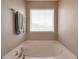 Bright bathroom features a soaking tub beneath a window, offering a relaxing retreat within the home at 310 Oak Leaf Pl, Acworth, GA 30102