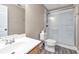 Modern bathroom featuring a white vanity, a toilet, and a glass-enclosed shower for a clean and functional design at 310 Oak Leaf Pl, Acworth, GA 30102