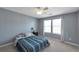 Serene bedroom with a queen bed, a dark nightstand, and a large window, providing a tranquil retreat at 310 Oak Leaf Pl, Acworth, GA 30102