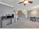 Open-concept living room with modern furnishings, a ceiling fan, and a staircase leading to upper levels at 310 Oak Leaf Pl, Acworth, GA 30102